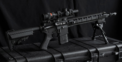 A mid-length 5.56mm AR 15 with attached adjustable bipod with scope.