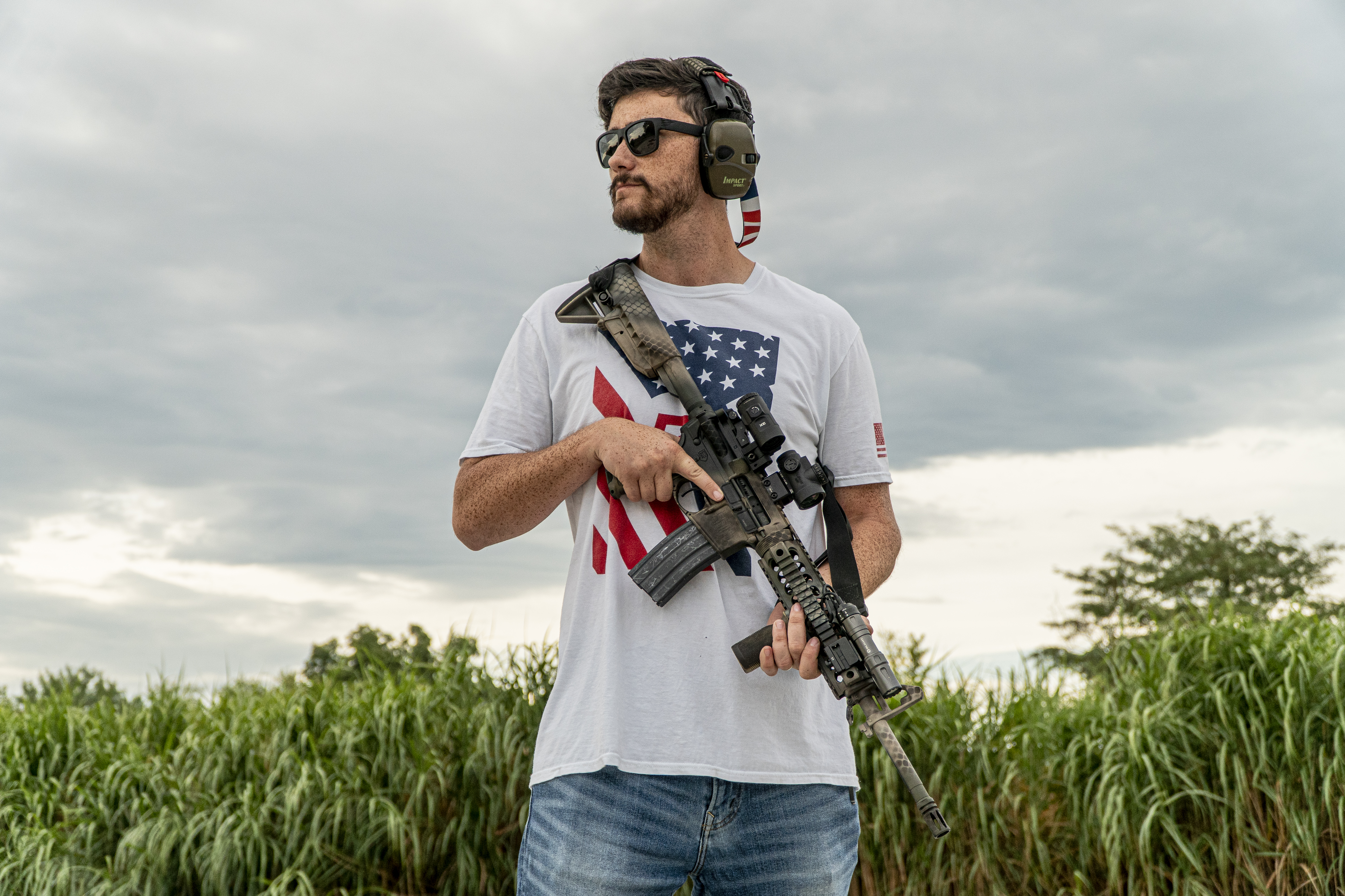 Man standing with camo AR15 rifle