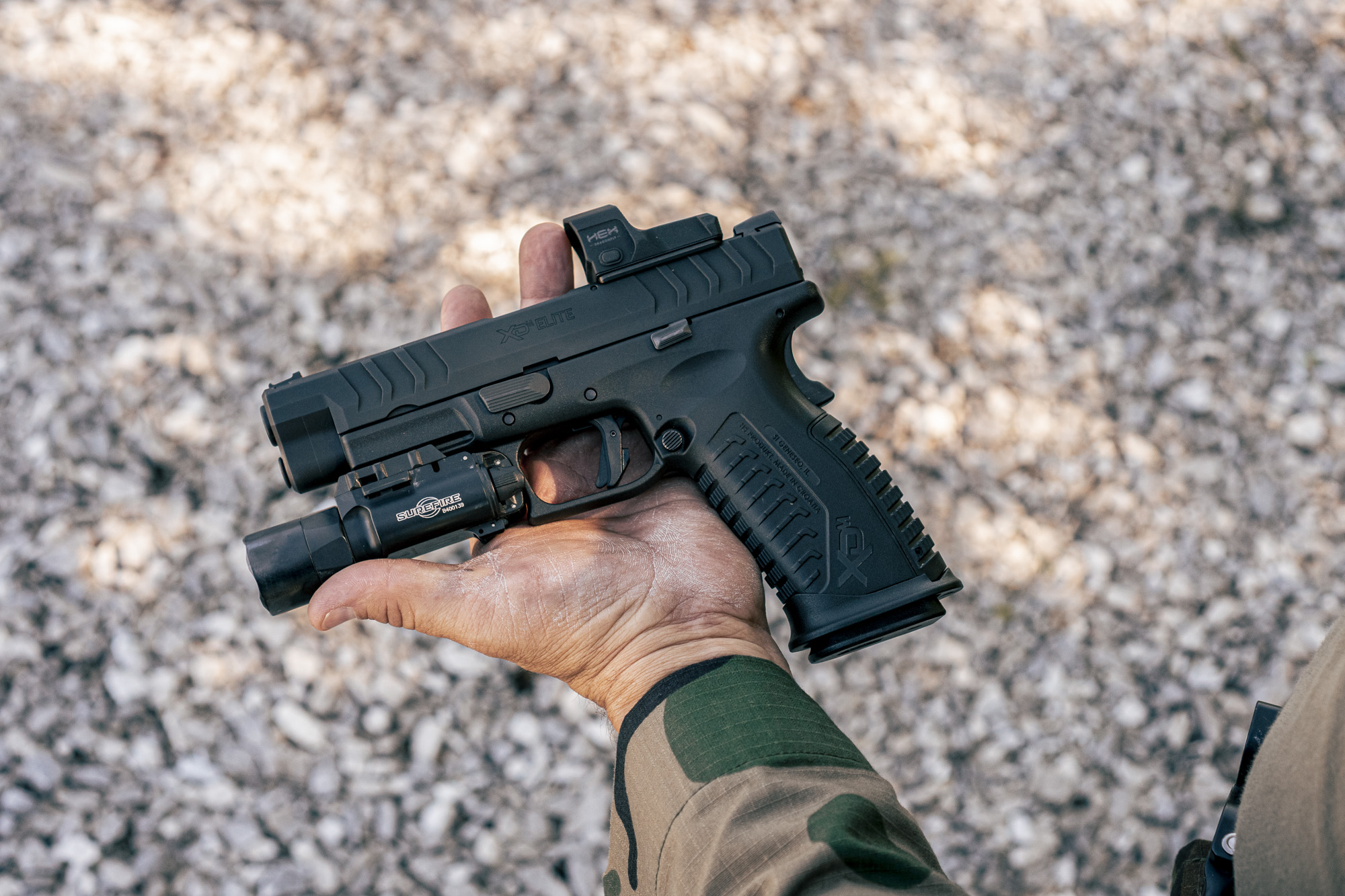 XDM elite held by man in green shirt